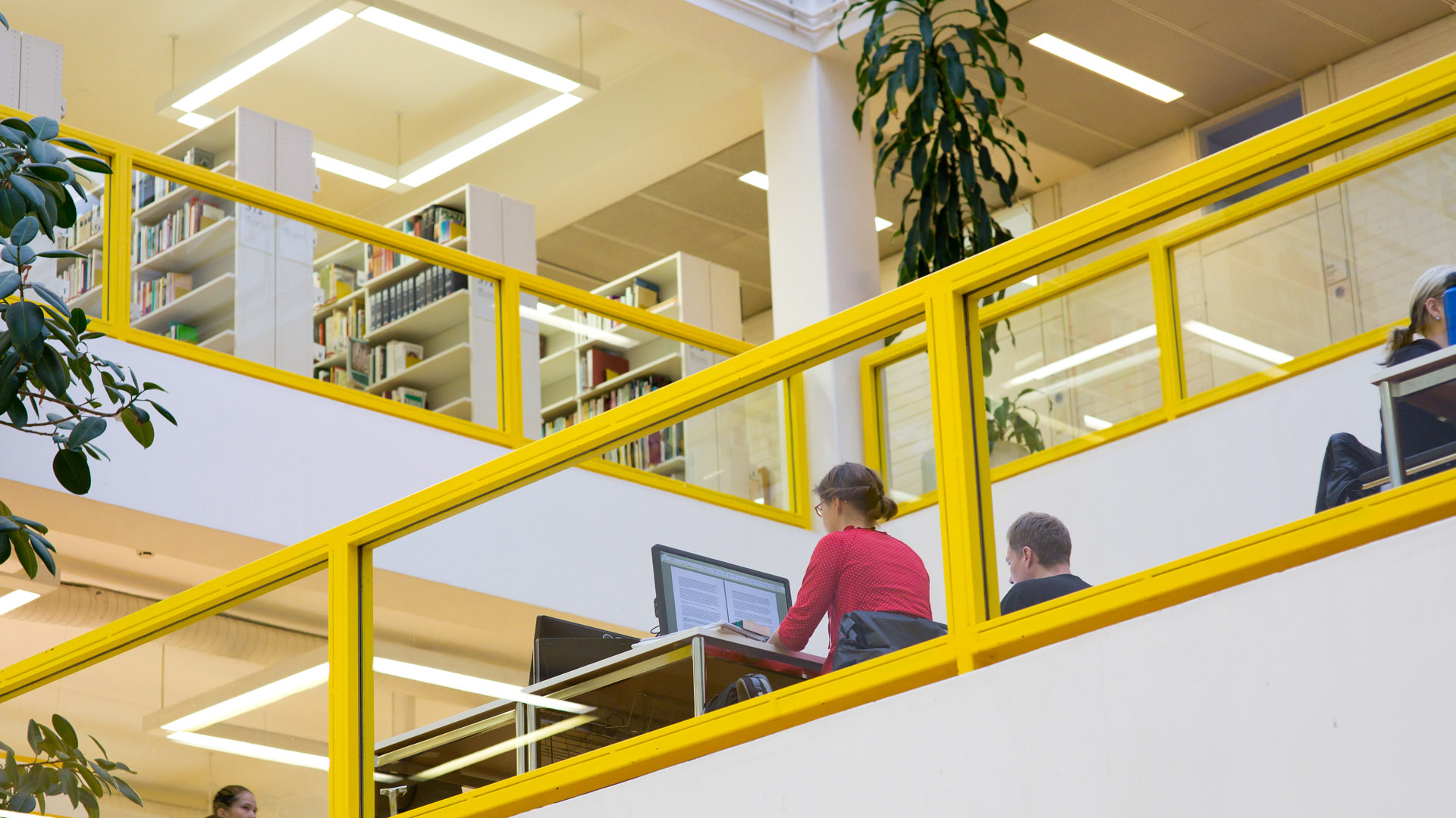 A library with people working on computers.